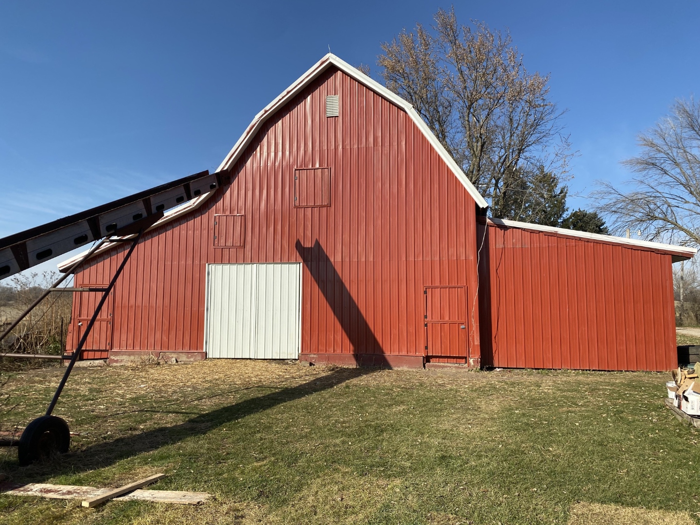 Barn with new red metal siding and fresh paint Iowa