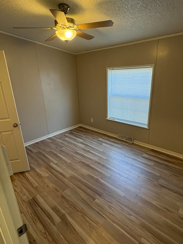 Bedroom after — painted walls, LVP flooring