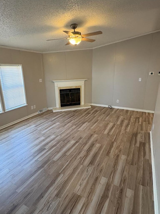 Fireplace room after — LVP flooring, painted mantle
