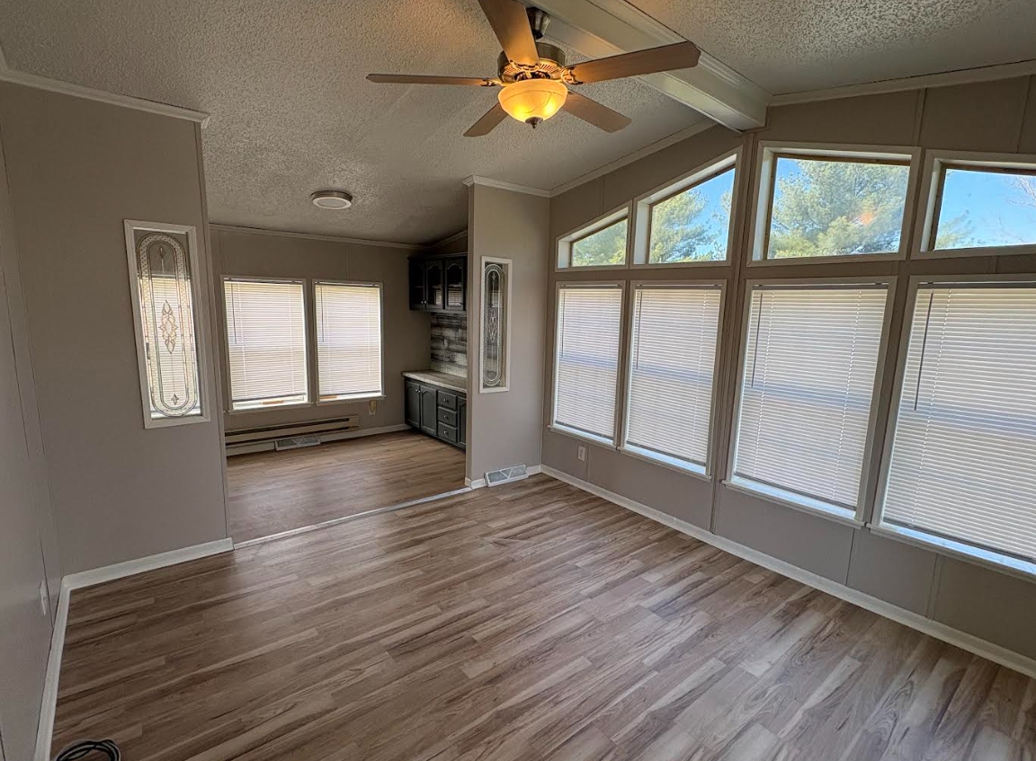 Living room after — LVP flooring, fresh paint