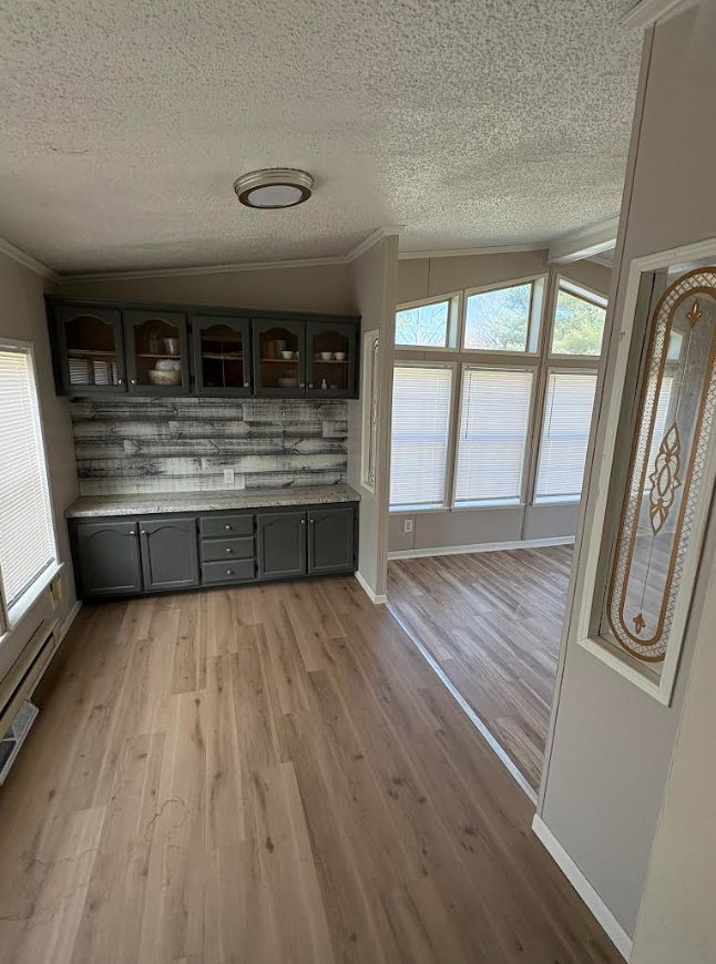 Dining nook after — painted cabinets, new backsplash, LVP